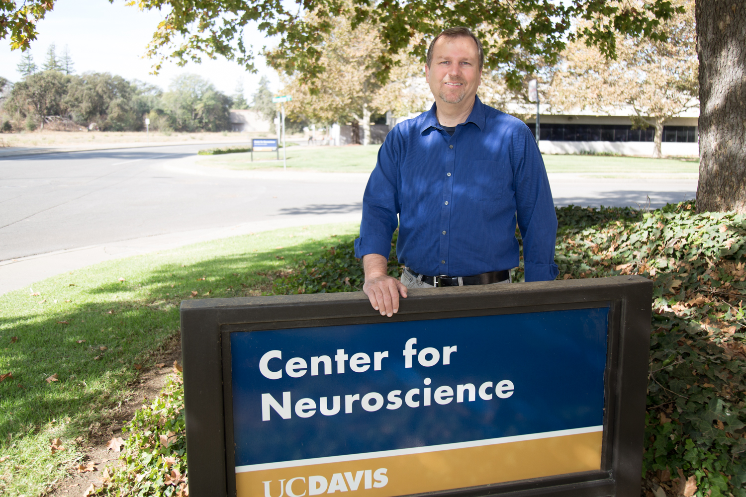 Picture of Marty in front of the center for neuroscience sign