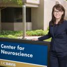 picture of kim next to the center for neuroscience sign
