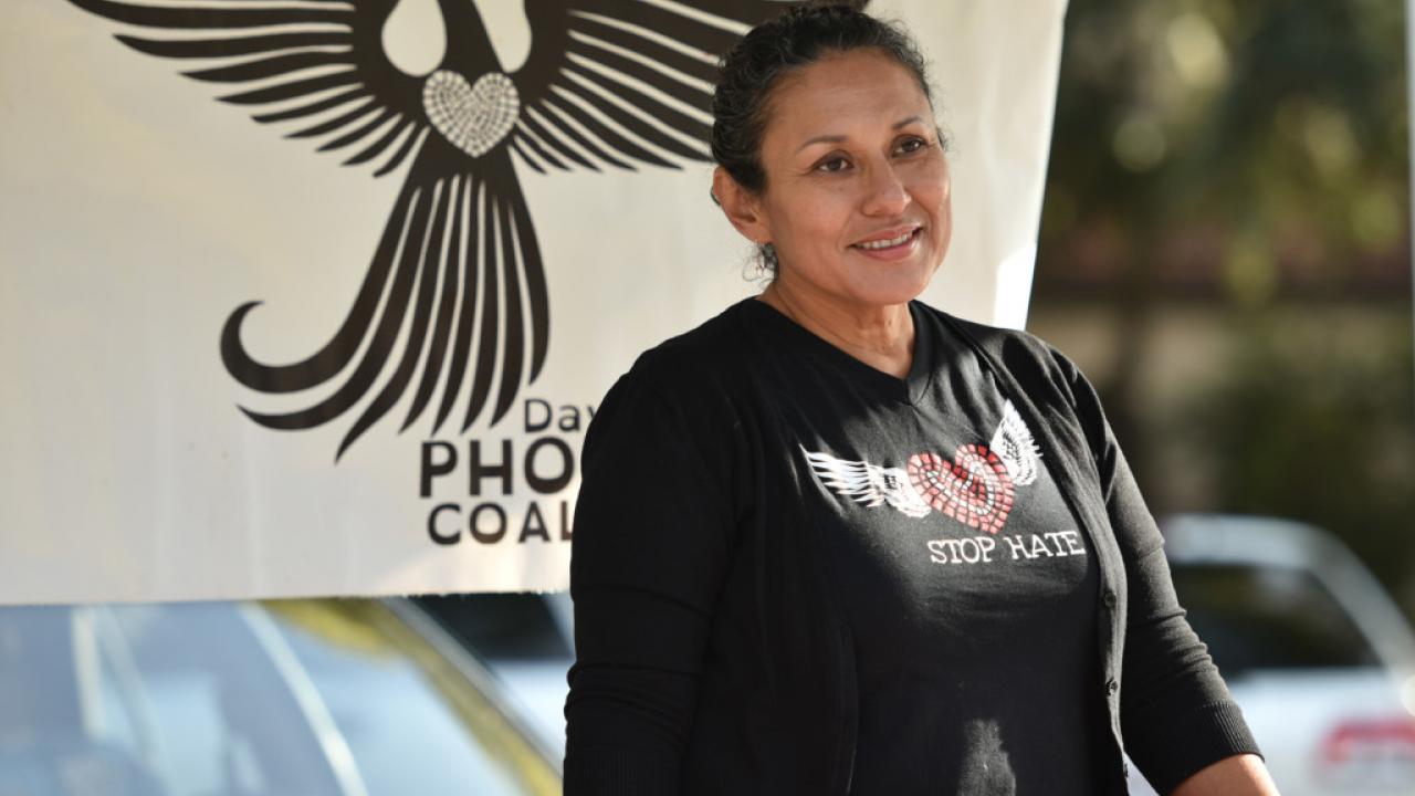 Gloria Partida, co-founder of the Davis Phoenix Coalition, staffs the nonprofit's booth Saturday morning at the Davis Farmers Market. Partida has been selected to receive the city's A.G. Brinley Plaque for special service. Wayne Tilcock/Enterprise photo Picture of Gloria
